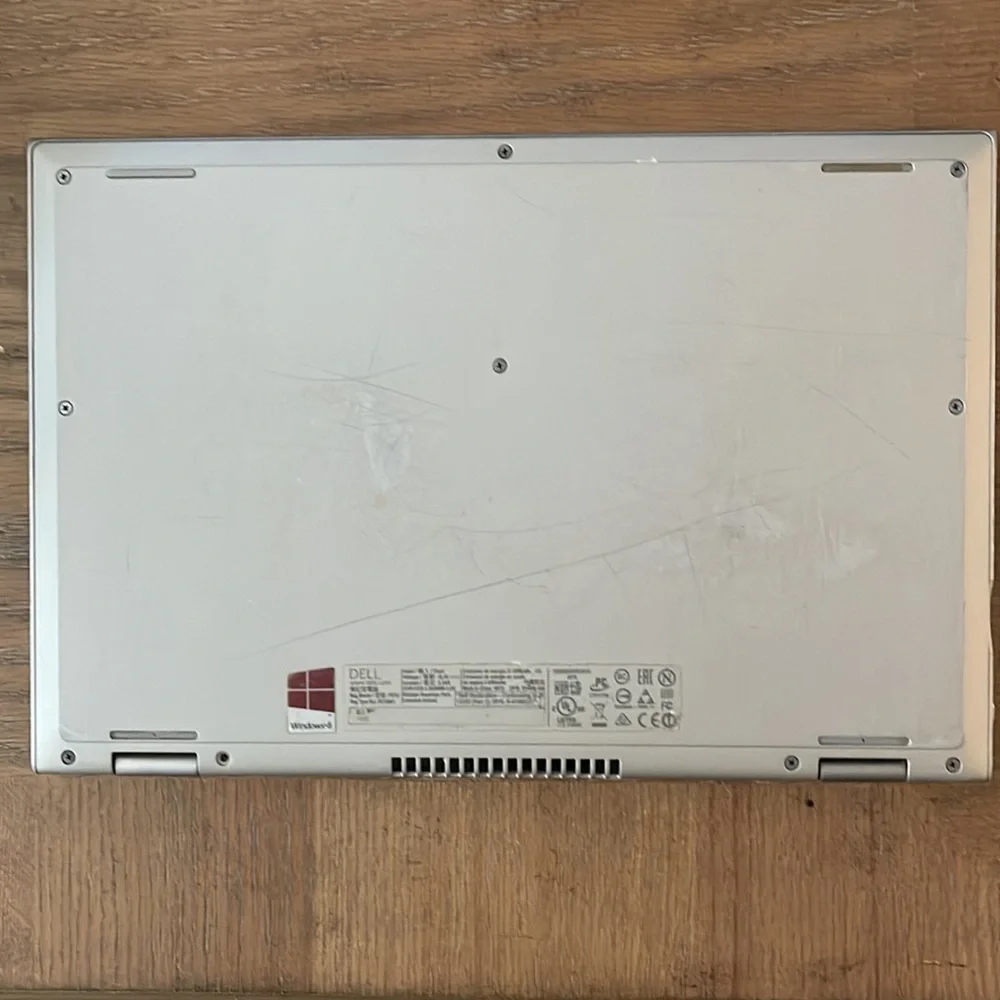 Silver Dell laptop that folds over to a tablet